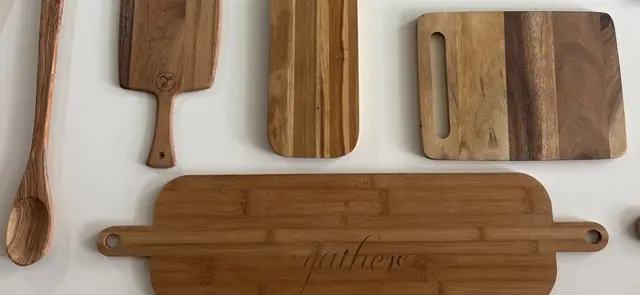 Wooden cutting boards on display at Solomon's Oven, including one engraved "gather"